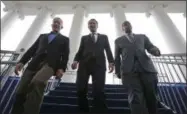  ?? AP PHOTO/STEVE HELBER, FILE ?? FILE - In this Jan. 12, 2018 file photo, Virginia Gov.-elect, Lt. Gov Ralph Northam, center, walks down the reviewing stand with Lt. Gov-elect, Justin Fairfax, right, and Attorney General Mark Herring at the Capitol in Richmond, Va. The political crisis in Virginia exploded Wednesday, Feb. 6, 2019, when the state’s attorney general confessed to putting on blackface in the 1980s and a woman went public with detailed allegation­s of sexual assault against the lieutenant governor. With Northam’s career already hanging by a thread over a racist photo, the day’s developmen­ts threatened to take down all three of Virginia’s top elected officials.