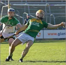  ??  ?? Peter Atkinson stretches to hold on to possession with Tomás Furlong of Cloughbawn breathing down his neck.