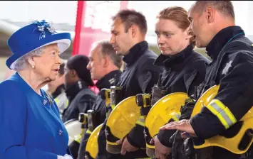  ??  ?? Honouring the heroes: The Queen speaks to firefighte­rs who lined up outside