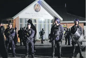  ?? THE ASSOCIATED PRESS ?? Security officers stand guard outside the Orthodox Assyrian church in Sydney, Australia, on Monday, after two people were attacked inside.