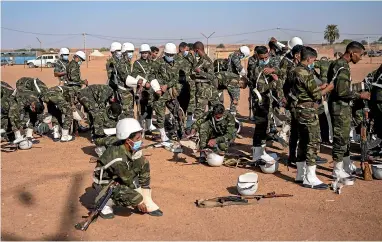  ?? AP ?? Soldiers from the Polisario Front pack after a National Unity Day event in the Dajla refugee camp in Algeria.