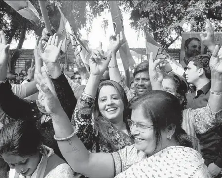  ?? Sajjad Hussain AFP/Getty Images ?? SUPPORTERS celebrate outside Indian National Congress headquarte­rs in New Delhi. Early returns showed the party, India’s main opposition, winning in Rajasthan, Chhattisga­rh and Madhya Pradesh states, leaving Prime Minister Narendra Modi politicall­y vulnerable.