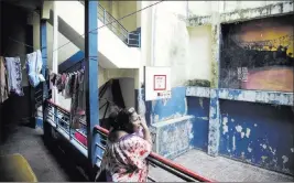  ?? Arnulfo Franco ?? The Associated Press Esther Marina Sanchez stands June 5 on a balcony inside the abandoned Nicolas Pacheco school building in Panama City. Sanchez and her relatives were forced out of their homes amid a real estate boom.