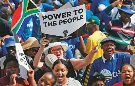  ?? AFP ?? People hold anti-Zuma banners during a rally organised by the newly formed “Freedom Movement” which comprises opposition parties, religious community and civil society, at Caledonian Stadium on Thursday in Pretoria.