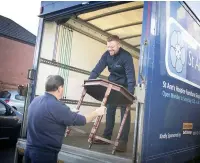  ??  ?? ●●Ryan Perkins from the hospice trading company unloads furniture