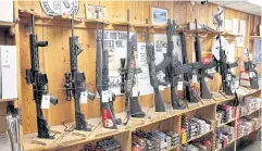  ?? ?? OFF-LIMITS: Assault-style rifles now banned for sale in the state are displayed at Freddie Bear Sports on Wednesday in Tinley Park, Illinois.