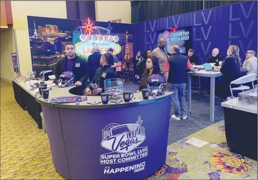  ?? CASE KEEFER ?? Members of the Las Vegas Super Bowl Host Committee work their booth in Phoenix at the Super Bowl 57 Media Center.