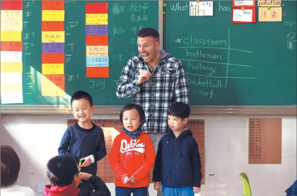  ?? PHOTOS BY ZOU HONG / CHINA DAILY ?? Brad Walsh, a Canadian teacher at ETU, with some of his students.