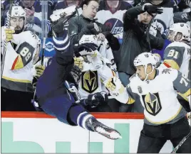  ?? John Woods ?? The Associated Press Jets right wing Blake Wheeler gets upended into the Vegas bench by Golden Knights right wing Ryan Reaves, right, in Game 1 of the Western Conference Final on Saturday in Winnipeg, Manitoba.