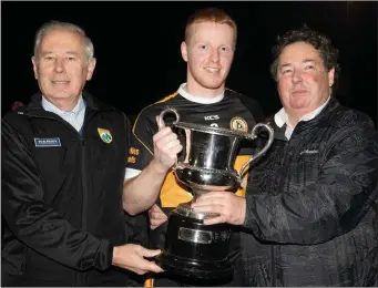  ??  ?? Christy Killeen (Kerry County Committee) and Eddie Barrett, who presented the Tommy Barrett Memorial Junior Cup to Austin Stack captain Barry Walsh after Stack defeated Annascaul in the final at Caherslee Photo by Joe Hanley