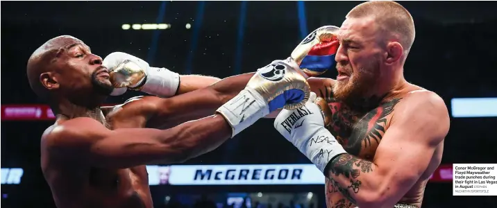  ?? STEPHEN McCARTHY/SPORTSFILE ?? Conor McGregor and Floyd Mayweather trade punches during their fight in Las Vegas in August