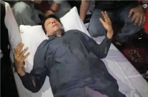  ?? AP ?? I heard a burst of bullet shots after which I saw Imran Khan and his aides fall down on the truck.
During the chaos that followed the shooting, Imran Khan had calmed his supporters and told them ‘not to panic.’