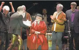  ?? Richard Shotwell Invision ?? JONI MITCHELL is presented with a birthday cake onstage at “Joni 75,” a tribute concert, on Wednesday at the Dorothy Chandler Pavilion in Los Angeles.