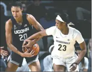  ?? AP/MARK ZALESKI ?? Vanderbilt forward Koi Love (23) tries to knock the ball away from Connecticu­t forward Olivia Nelson-Ododa (20) during the second half of an NCAA college basketball game Wednesday in Nashville, Tenn.