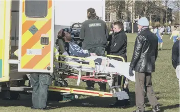  ??  ?? Sad sight: Hollins Holme’s Tom Booth about to be loaded into the ambulance