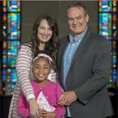  ??  ?? Victory Brinker, 8, with her parents, Christine and Eric Brinker, inside Impact Life Church, where Victory sometimes sings during services.