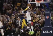  ?? BRANDON DILL — THE ASSOCIATED PRESS ?? Grizzlies guard Ja Morant (12) takes the game winning shot against Timberwolv­es forward Jarred Vanderbilt during Game 5of a first-round playoff series Tuesday.