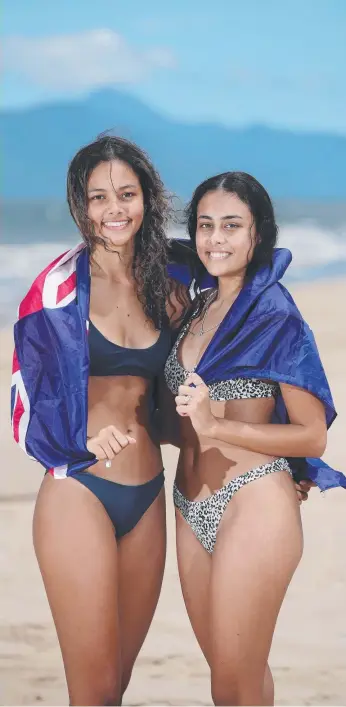  ??  ?? Whitfield sisters Zaphia Sumner, 17, and Kiara Sumner, 15, fly the Australian flag on the beach for Australia Day. Picture: Brendan Radke