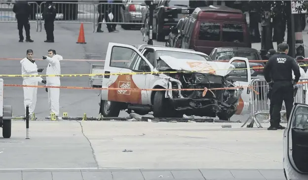  ?? PICTURE: JEWEL SAMAD/GETTY ?? 0 New York Police Department forensic teams beside the hired pick-up which was used in the attack, which left eight dead and 12 seriously injured