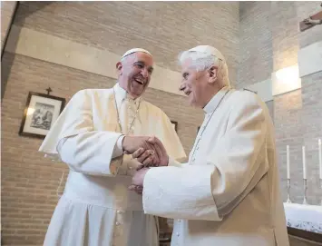  ?? — GETTY IMAGES ?? Pope Francis, left, and Pope Emeritus Benedict XVI share a moment after Francis created 17 new cardinals from around the globe on Saturday.