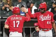  ?? ?? Kyle Farmer is greeted by Aristides Aquino after scoring the Reds’ lone run Wednesday in the ninth inning of a 6-1 loss in Chicago. The Reds are playing out the string after being eliminated from playoff contention.