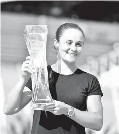  ??  ?? Ashleigh Barty of Australia poses with the winners trophy after defeating Karolina Pliskova of the Czech Republic during the Women’s Final match on day 13 of the Miami Open presented by Itau at Hard Rock Stadium on March 30, 2019 in Miami Gardens, Florida. - AFP photo