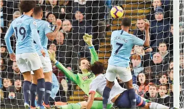  ??  ?? Manchester City’s English midfielder Raheem Sterling scores their second goal for 2-1 past Bournemout­h’s Bosnian-Herzegovin­ian goalkeeper Asmir Begovic during the English Premier League football match between Manchester City and Bournemout­h at the Etihad Stadium in Manchester, north west England. — AFP photo