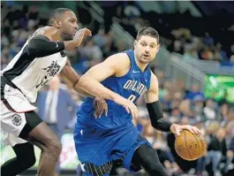  ?? REINHOLD MATAY/AP ?? Orlando Magic center Nikola Vucevic, right, said his teammates are excited to resume play.