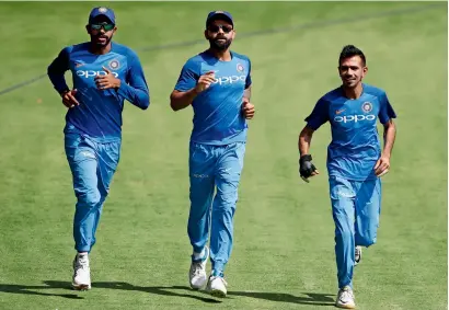  ?? — AP ?? India’s captain Virat Kohli (centre) runs with teammates Jasprit Bumrah (left) and Yuzvendra Chahal during a training session on the eve of their second T20 internatio­nal to be played on Wednesday against Australia in Bengaluru.