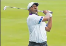  ?? Chris Carlson The Associated Press ?? Harold Varner III follows through on a shot from the 18th fairway Thursday in the first round of the Wyndham Championsh­ip at Sedgefield Country Club.