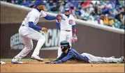  ??  ?? Braves shortstop Dansby Swanson dives safely into second base as Cubs shortstop Addison Russell waits for the throw during Atlanta’s 4-0 win at Wrigley Field.