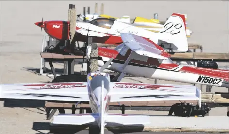  ?? PHOTOS by randy HOEFT/YUMA SUN ?? buy these photos at Yumasun.com A FULL LINEUP of radio controlled model aircraft wait to take to the air Thursday.