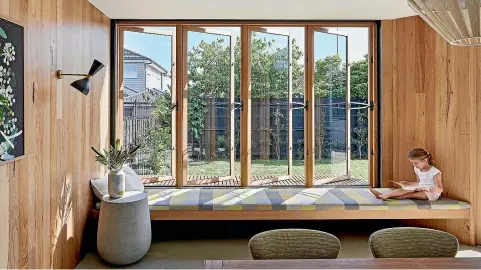  ?? PHOTO: ANDY MACPHERSON ?? A long window seat is the perfect place to relax with a book. This seat is within an extension to a traditiona­l 50s brick house, part of a renovation by Bent Architectu­re.