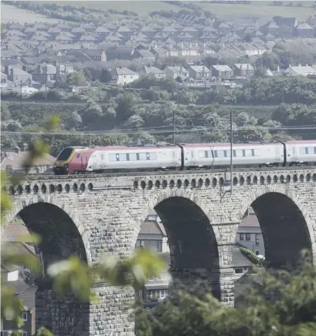  ??  ?? 0 A Virgin (and Stagecoach) train crosses a bridge near Berwick upon Tweed
PICTURE: CRAIG STEPHEN