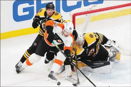  ??  ?? Philadelph­ia Flyers’ James van Riemsdyk (25) tries to get a shot on Boston Bruins’ Dan Vladar (80) as Connor Clifton (75) defends during the third period of an NHL hockey game, on April 5, in Boston. (AP)