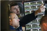  ?? ASSOCIATED PRESS FILE PHOTO ?? Traders work on the floor at the New York Stock Exchange in New York, Nov. 10.