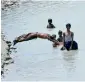  ?? APP ?? A boy dives into a canal as others watch on in Hyderabad on Monday. —