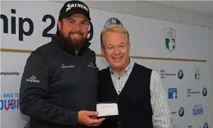  ??  ?? Shane Lowry is presented with honorary life membership of the European Tour by chief executive Keith Pelley. Photograph: Andrew Redington/Getty Images