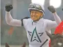  ?? JEFF ROBERSON/THE ASSOCIATED PRESS ?? Jockey Mike Smith celebrates after riding Justify to victory Saturday in the Kentucky Derby. He earned his second Derby victory, becoming at 52 the second-oldest winning jockey.