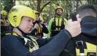  ?? The Associated Press ?? RESCUE TRAINING: The swift water rescue team at Yosemite National Park, Calif., prepare for training May 25 in the frigid and swift water of the Merced River.