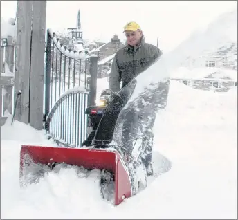  ?? SUEANN MUSICK/THE NEWS ?? Laurie MacDonald of Pictou makes a path in the Hector Heritage Quay on Thursday after 20 centimetre­s of snow was dumped on the county. The museum is closed for the winter but it is important to keep doorways cleared for fire safety and insurance...