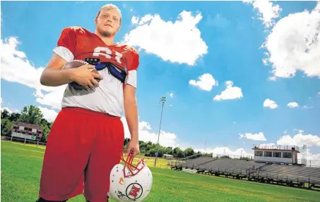  ??  ?? McLoud High School lineman Dyllan Nichols poses for a photo on the football field in McLoud on Wednesday. Nichols underwent chemothera­py treatments all summer, and is now healthy and ready for the start of the season on Friday against rival Harrah.