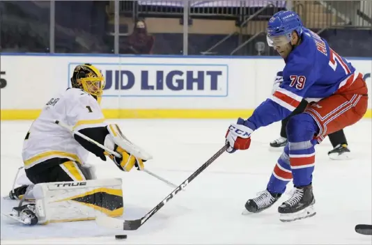  ?? Associated Press ?? New York Rangers forward K’Andre Miller (79) shoots as Penguins goalie Casey DeSmith (1) defends during Monday’s game at Madison Square Garden in New York.