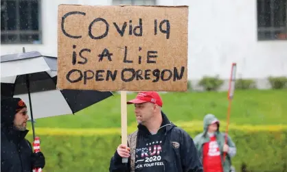  ??  ?? A demonstrat­or demands the reopening of Oregon at a protest in Salem, Oregon. Photograph: Terray Sylvester/Getty Images