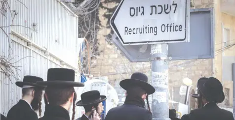  ?? (Chaim Goldberg/Flash90) ?? HAREDI MEN protest outside the IDF recruiting office in Jerusalem.