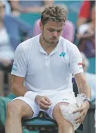  ?? KIRSTY WIGGLESWOR­TH ASSOCIATED PRESS FILE PHOTO ?? Switzerlan­d’s Stan Wawrinka ices his knee July 3 at Wimbledon in London. Defending champion Stan Wawrinka has pulled out of the U.S. Open with an injured knee.