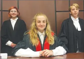  ?? DALE BOYD/Penticton Herald ?? Grade 7 KVR Middle School students Asia Palfrey, Alex Koturbash and Max MacIntyre don the appropriat­e robes as they prepare for Law Day on Wednesday at the Penticton courthouse. Local students will learn the ins and outs of the justice system through...