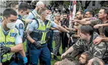  ?? STUFF ?? Police and protesters come face to face at Parliament in February. A wilful trespass charge against Palmerston North woman Moana Maaka was dismissed in Wellington District Court yesterday.