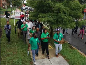  ?? (The Washington Post/Jahi Chikwendiu) ?? Washington, D.C., Mayor Muriel E. Bowser (middle front) conducts a public safety walk in Ward 5 with officials and community leaders last summer.