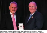  ??  ?? Uachtaráin Cumann Lúthchleas Gael John Horan presents Vincent Hogan, Chief Sports Feature Writer of the Irish Independen­t, with the 2017 McNamee Media award for the best article in a national newspaper for Vincent’s interview with Galway hurling star...